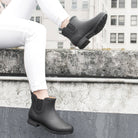Person wearing the Delridge Faux Fur Chelsea Rain Boot - Black